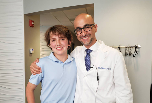 Dr. Maz Moshiri with a teenage boy patient