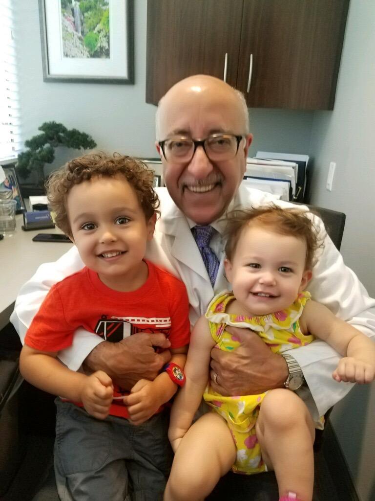Dr. Moshiri with his grandchildren, Shaya and Sadira, in his lap