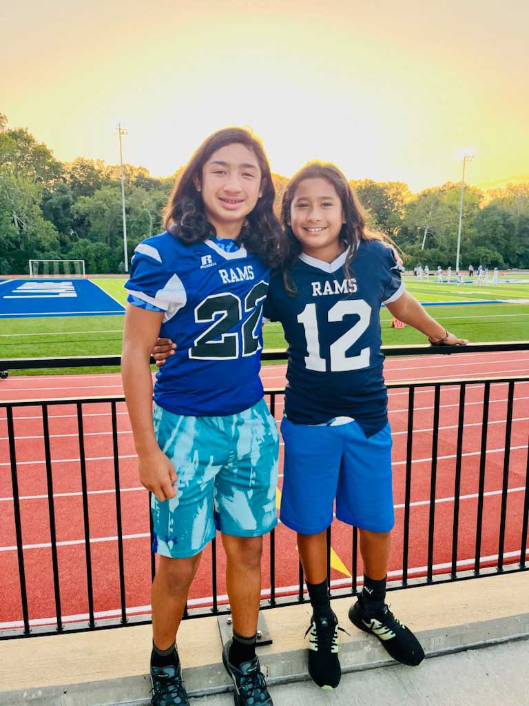 2 boys in football jerseys